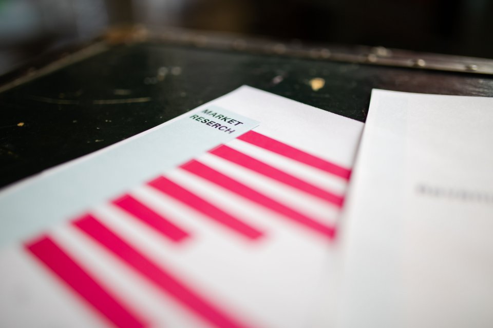 A printed market research document on a desk.