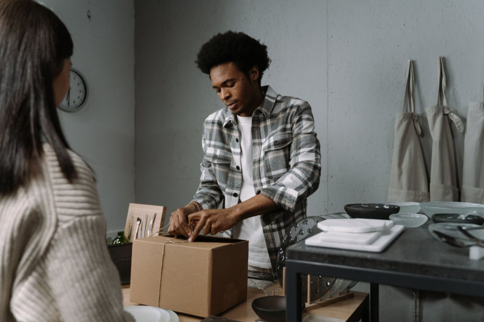 A retail worker preparing a customer order for dispatch.
