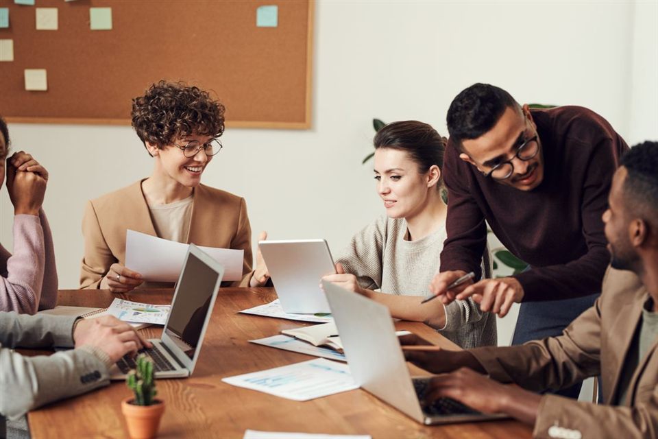 An illustrative team collaborating around a table.
